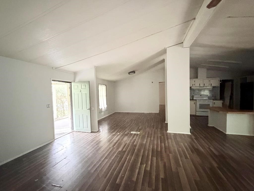 86 Whippoorwill Lane Trinity, TX 75862 - Photo 34 of 47 a view of a big room with wooden floor and a kitchen