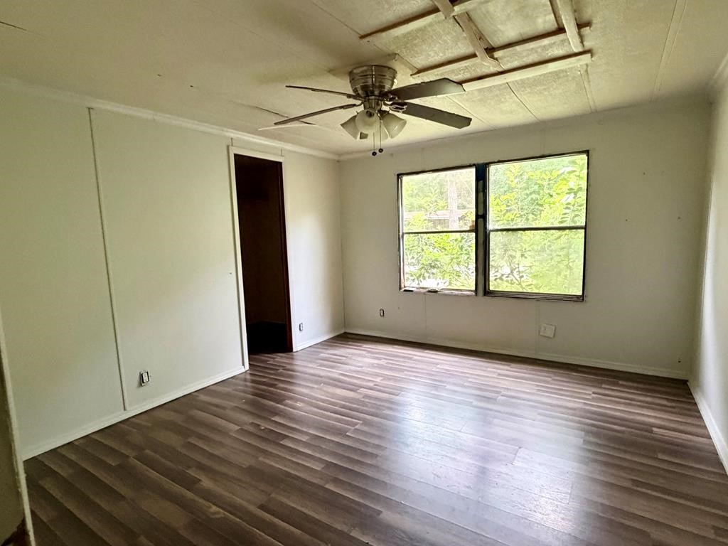 86 Whippoorwill Lane Trinity, TX 75862 - Photo 46 of 47 an empty room with wooden floor closet and windows