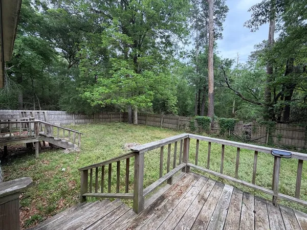 a view of balcony with deck and trees
