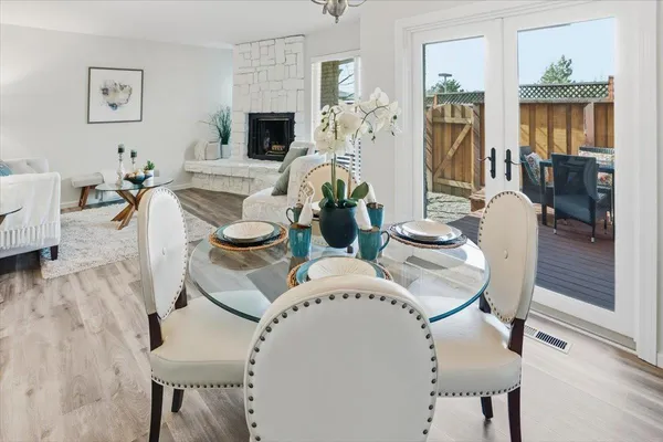 a living room with furniture a flat screen tv and wooden floor