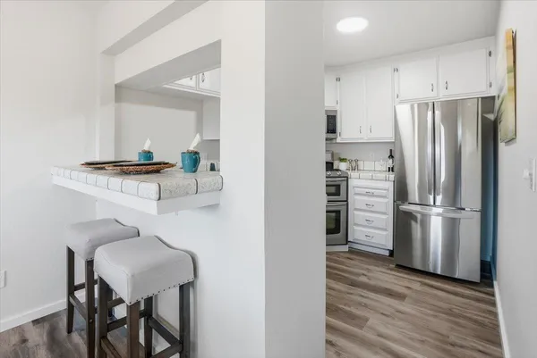 a kitchen with stainless steel appliances granite countertop a refrigerator and a stove top oven