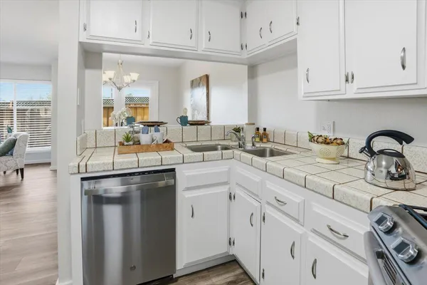a kitchen with stainless steel appliances granite countertop a sink and cabinets