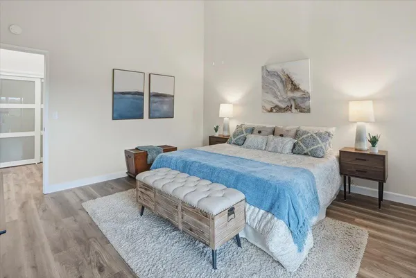 a bedroom with a bed and a painting on the wall