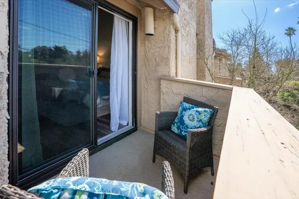 a view of a balcony with wooden floor and floor to ceiling window