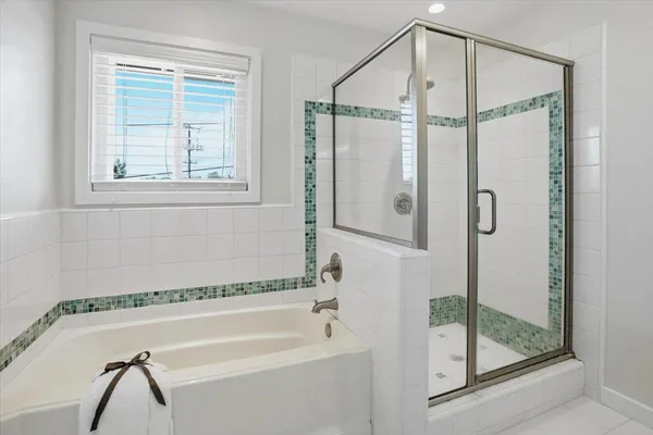 a bathroom with a shower and a bath tub