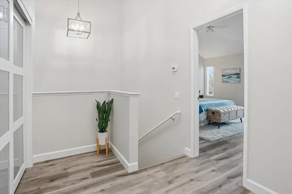 a view of a hallway and wooden floor and a livingroom