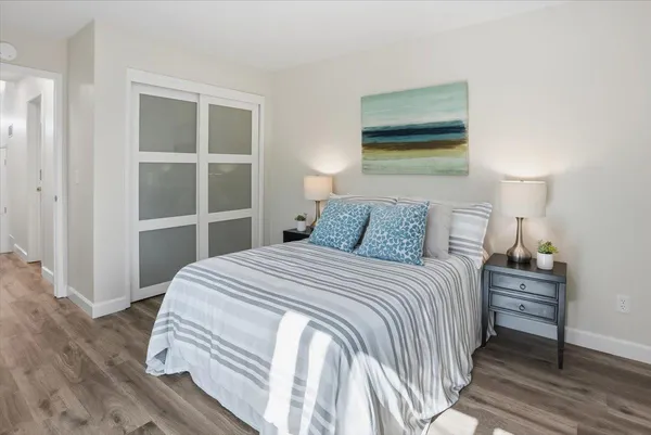 a bedroom with a bed and a lamp