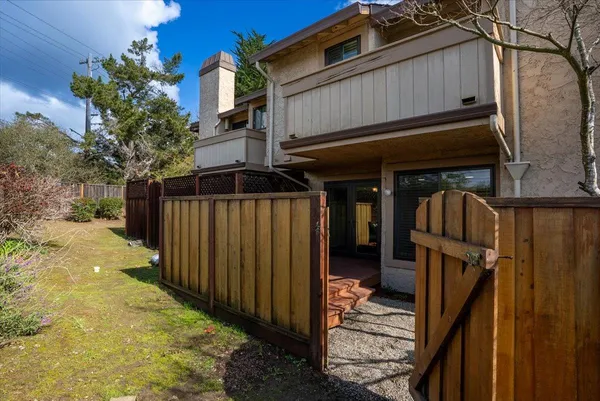 a view of a house with wooden fence