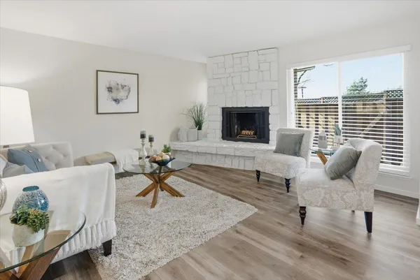a living room with furniture a fireplace and a table