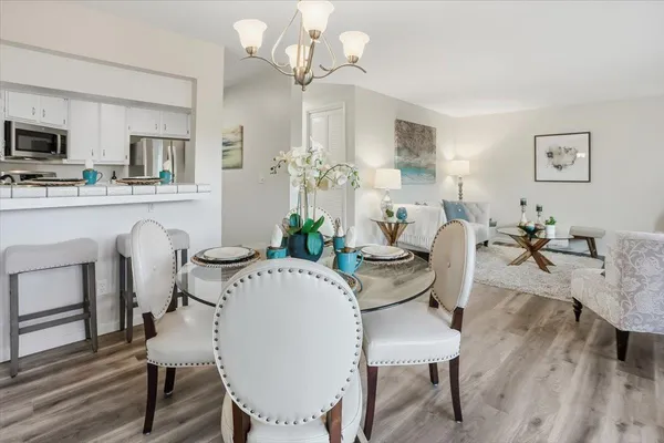 a view of a dining room with furniture and wooden floor