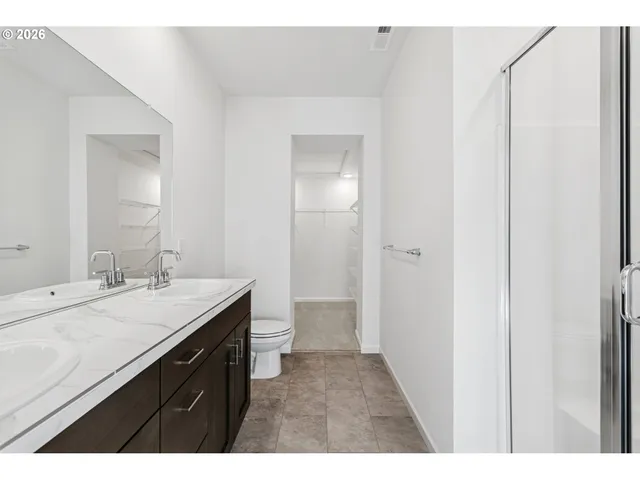 a bathroom with a sink vanity granite and a mirror