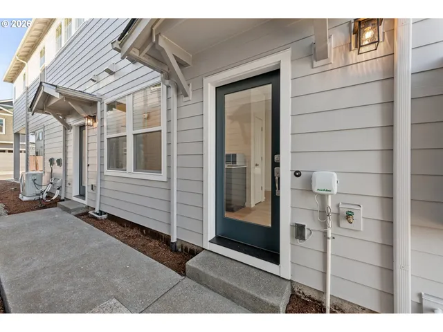a kitchen that has a lot of windows and brick walls