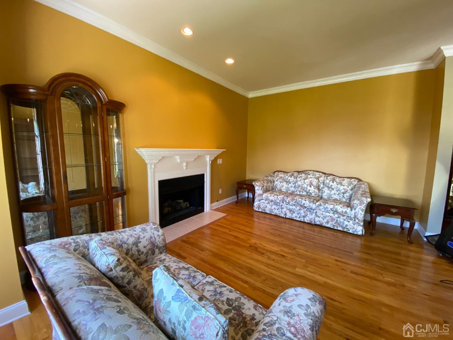 418 Cliff Road Sewaren, NJ 07077 - Photo 15 of 63 a bedroom with a bed and a fireplace