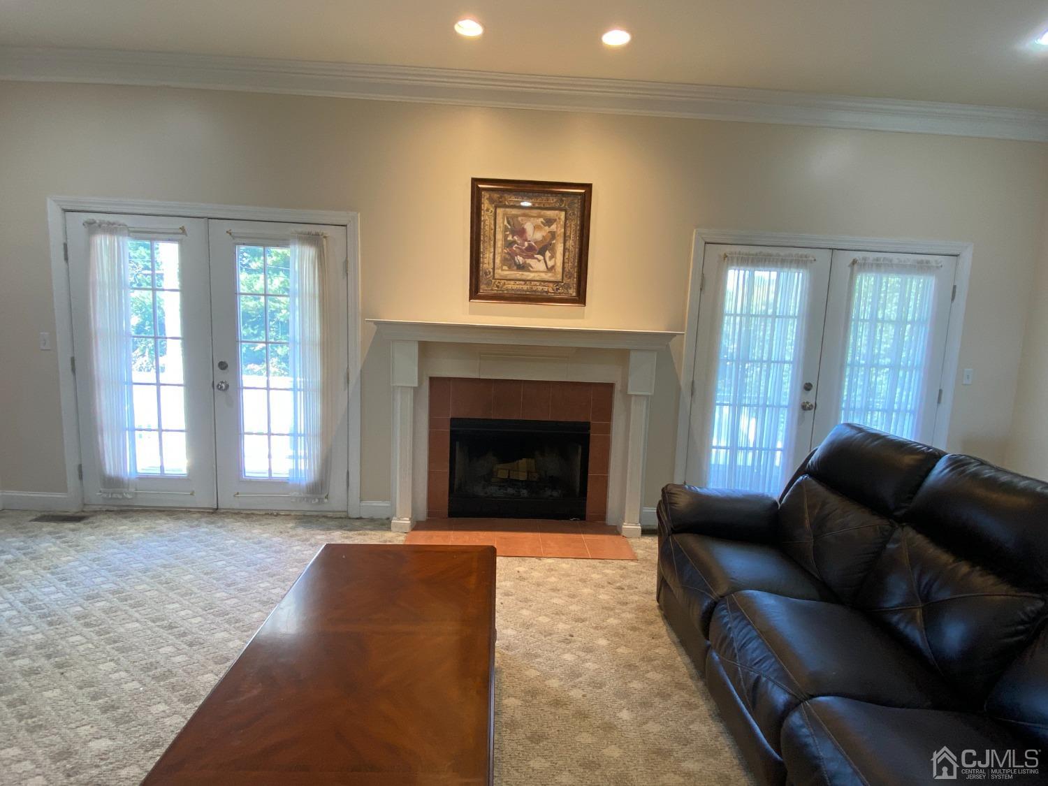 418 Cliff Road Sewaren, NJ 07077 - Photo 23 of 63 a living room with furniture and a fireplace