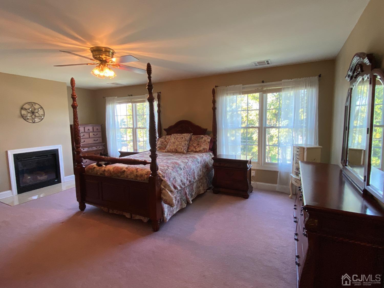 418 Cliff Road Sewaren, NJ 07077 - Photo 35 of 63 a spacious bedroom with a bed and a couch