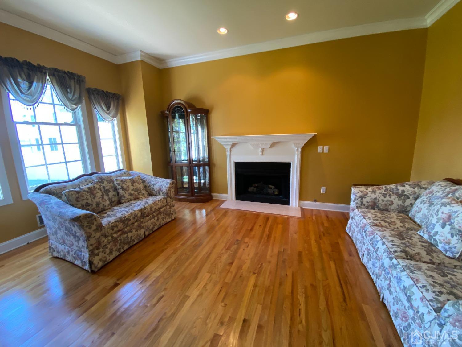 418 Cliff Road Sewaren, NJ 07077 - Photo 4 of 63 a living room with furniture and a fireplace