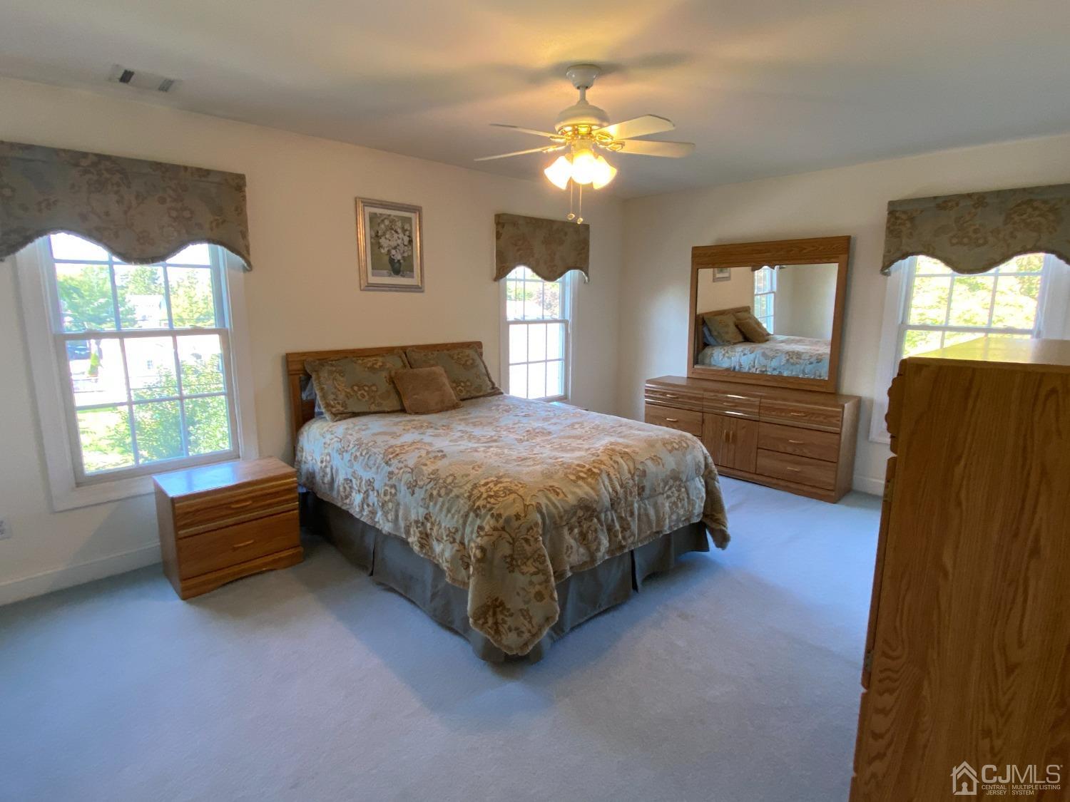 418 Cliff Road Sewaren, NJ 07077 - Photo 46 of 63 a bedroom with a bed mirror and window