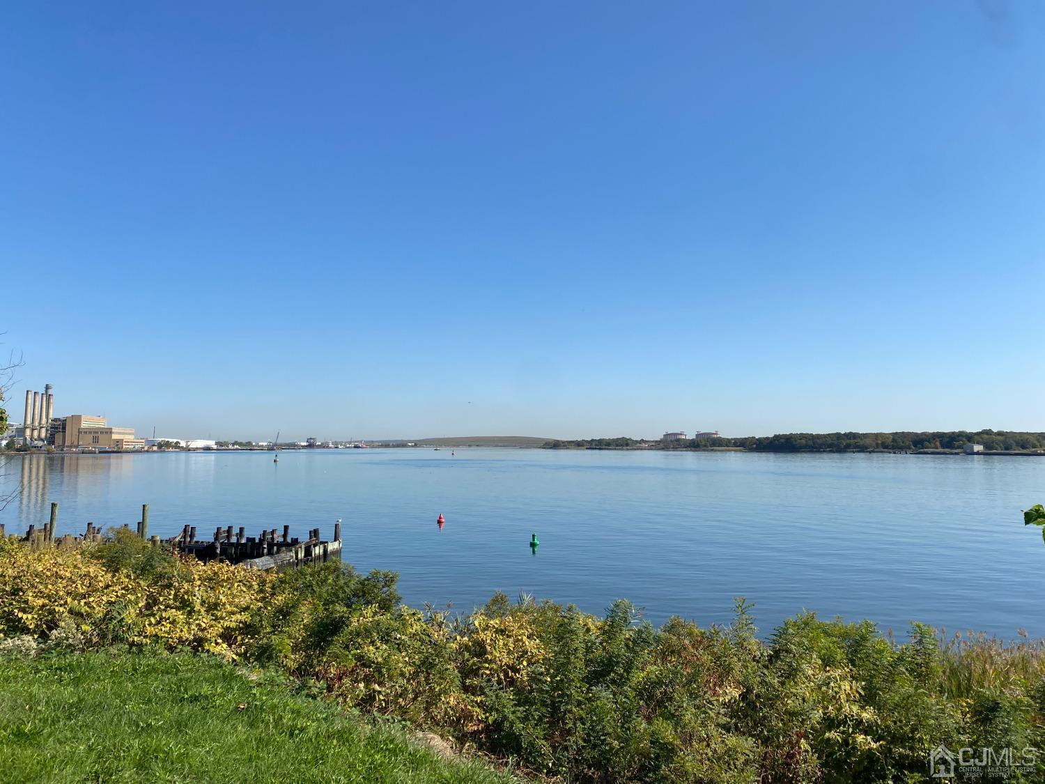 418 Cliff Road Sewaren, NJ 07077 - Photo 57 of 63 a view of a lake with plants in front of it