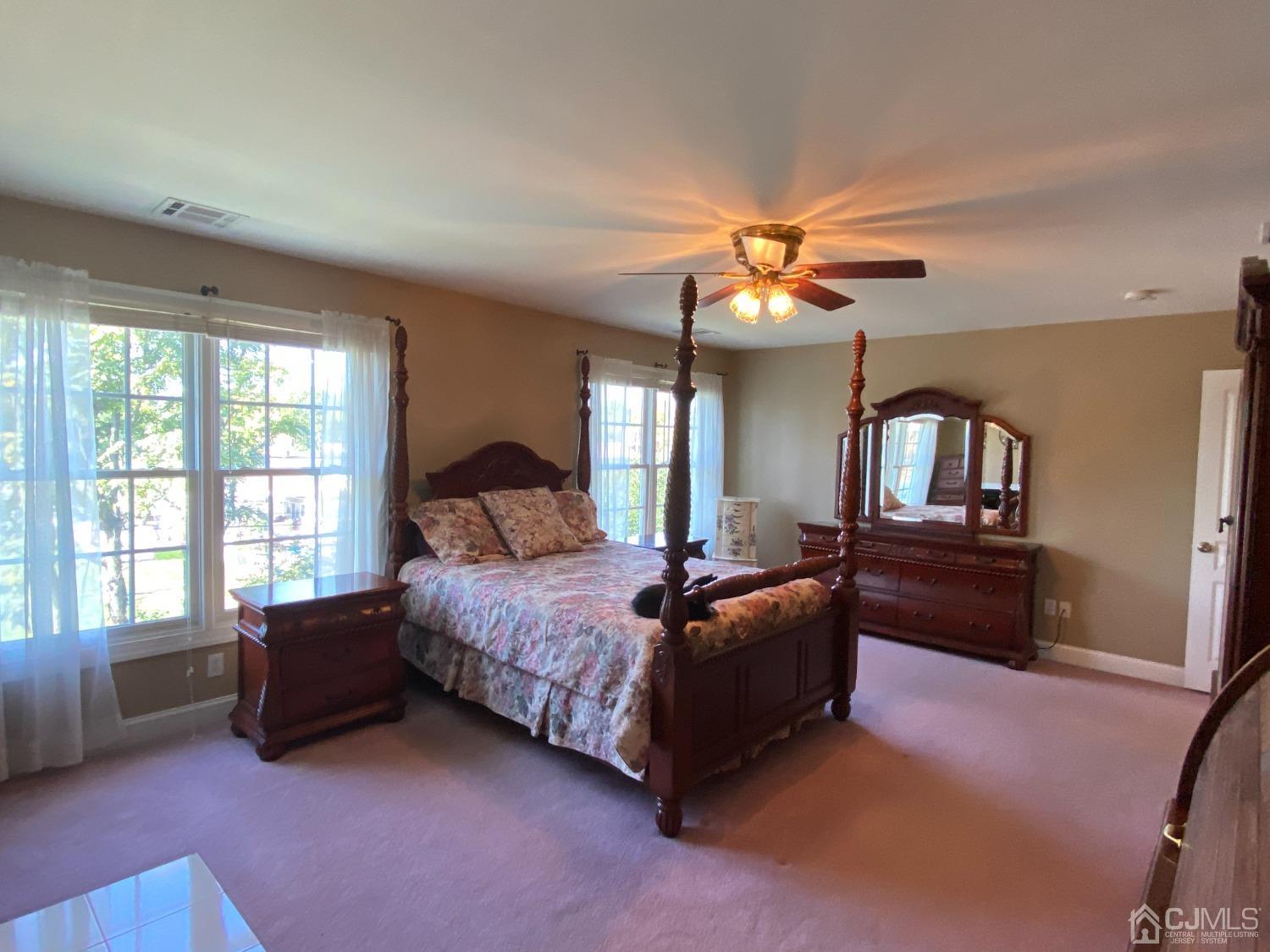 418 Cliff Road Sewaren, NJ 07077 - Photo 7 of 63 a spacious bedroom with a bed and a window
