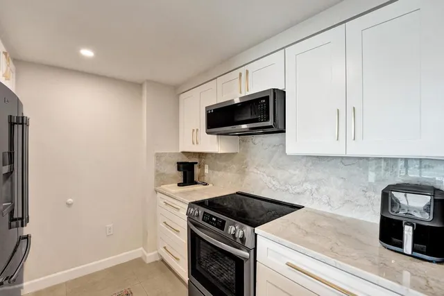 a kitchen with a stove and a microwave