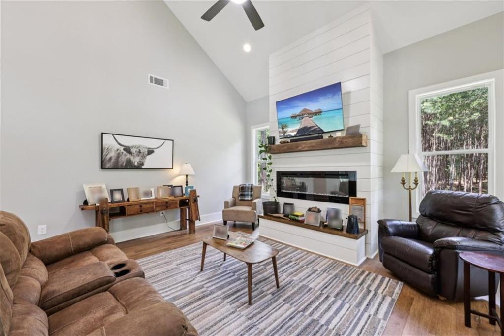 250 Stagecoach Road Oxford, GA 30054 - Photo 17 of 76 a living room with furniture a flat screen tv and a fireplace