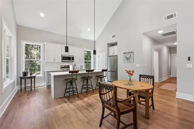 a view of a dining room with furniture window and wooden floor