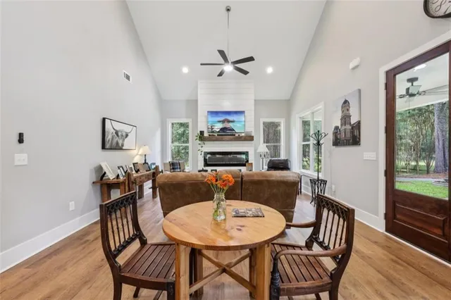 a kitchen with a table chairs refrigerator and microwave