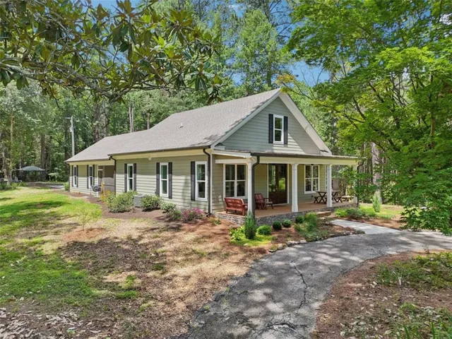 a front view of a house with garden and porch