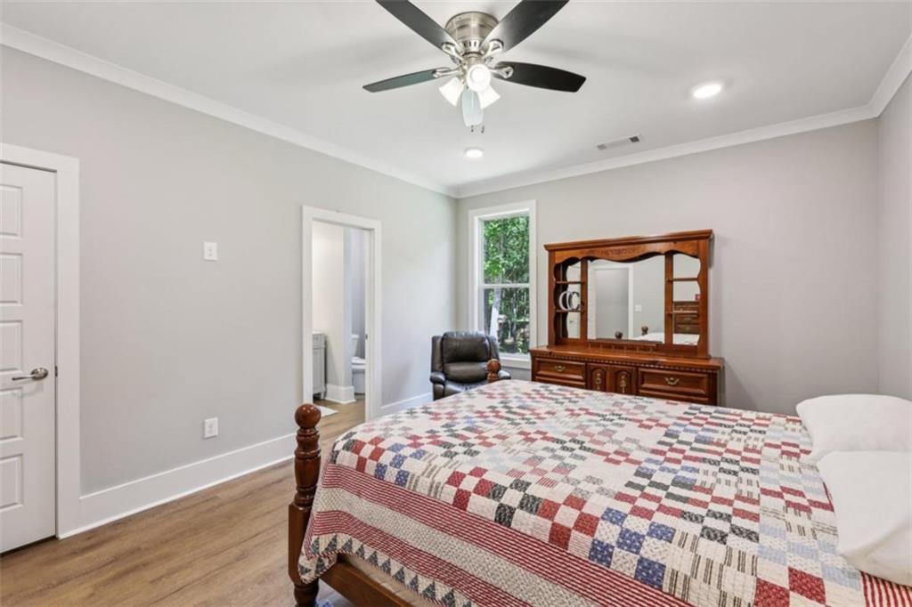 250 Stagecoach Road Oxford, GA 30054 - Photo 35 of 76 a bedroom with a large bed and a chandelier