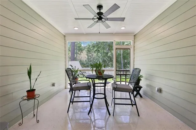 a view of a house with backyard and a tree