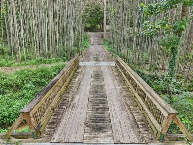 a view of a field with trees in the background
