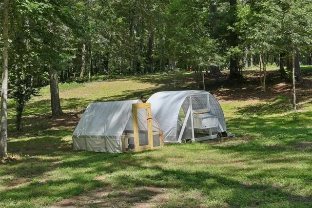 a view of a house with a yard and a tree