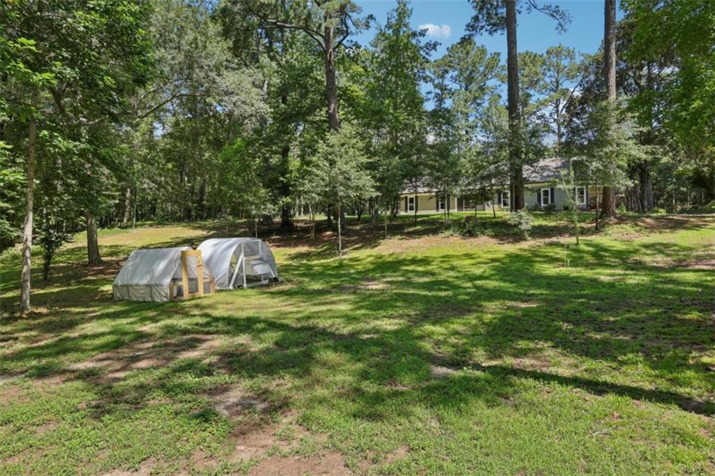 250 Stagecoach Road Oxford, GA 30054 - Photo 47 of 76 a backyard of a house with table and chairs