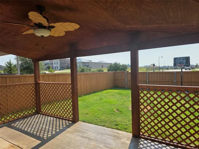 a view of a porch with wooden fence