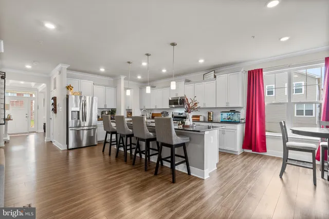 a kitchen with stainless steel appliances granite countertop a sink a stove and cabinets