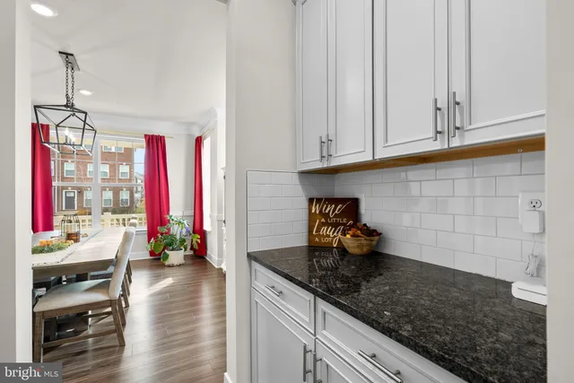 a kitchen with stainless steel appliances kitchen island granite countertop a stove and cabinets
