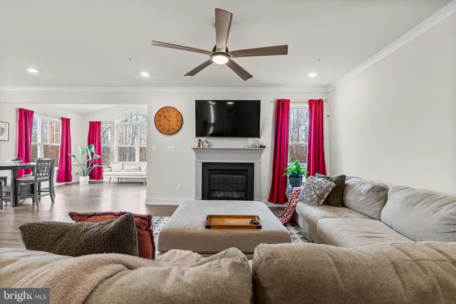 a living room with furniture fireplace and flat screen tv