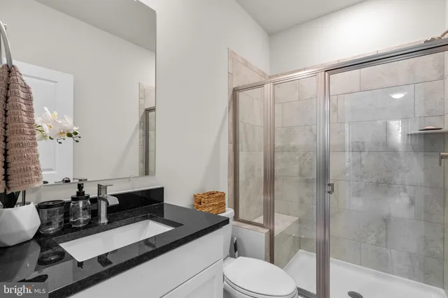 a bedroom with a bed a flat screen tv and dresser