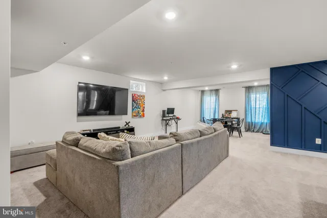 a bathroom with a granite countertop sink a toilet a mirror a bathtub and shower