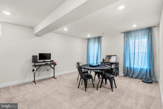 a view of a white house with a small yard and plants