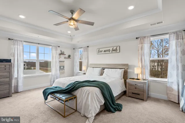 a bedroom with a bed couch and window