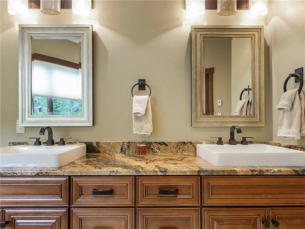 555 Independence Road Keystone, CO 80435 - Photo 14 of 33 a bathroom with a granite countertop sink and a mirror