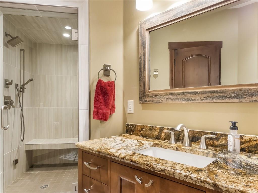 555 Independence Road Keystone, CO 80435 - Photo 22 of 33 a bathroom with a granite countertop sink and a mirror