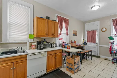 a view of a kitchen with a sink and cabinets