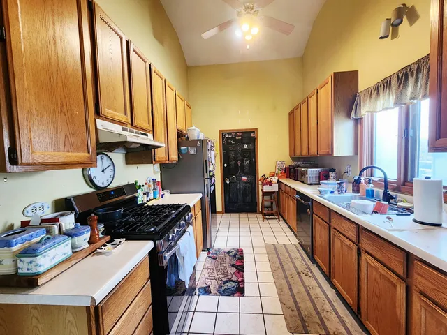 a kitchen with stainless steel appliances a sink stove and cabinets