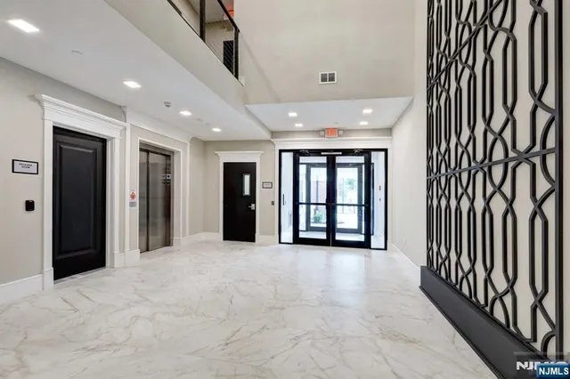 a view of an entryway with wooden floor