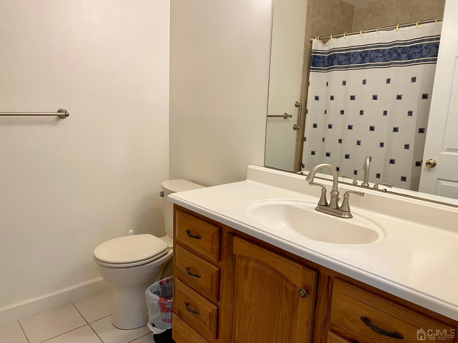 51 Boulder Drive Edison, NJ 08817 - Photo 11 of 24 a bathroom with a sink toilet and a mirror