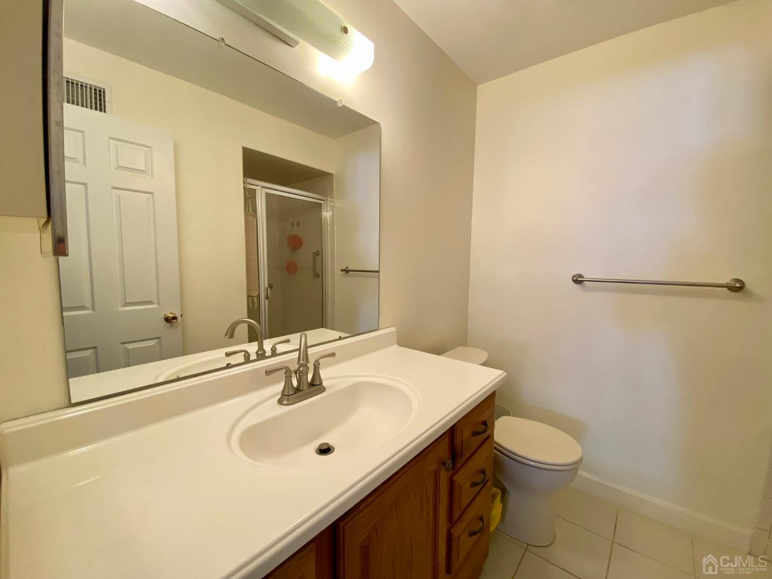 51 Boulder Drive Edison, NJ 08817 - Photo 16 of 24 a bathroom with a sink a toilet and shower
