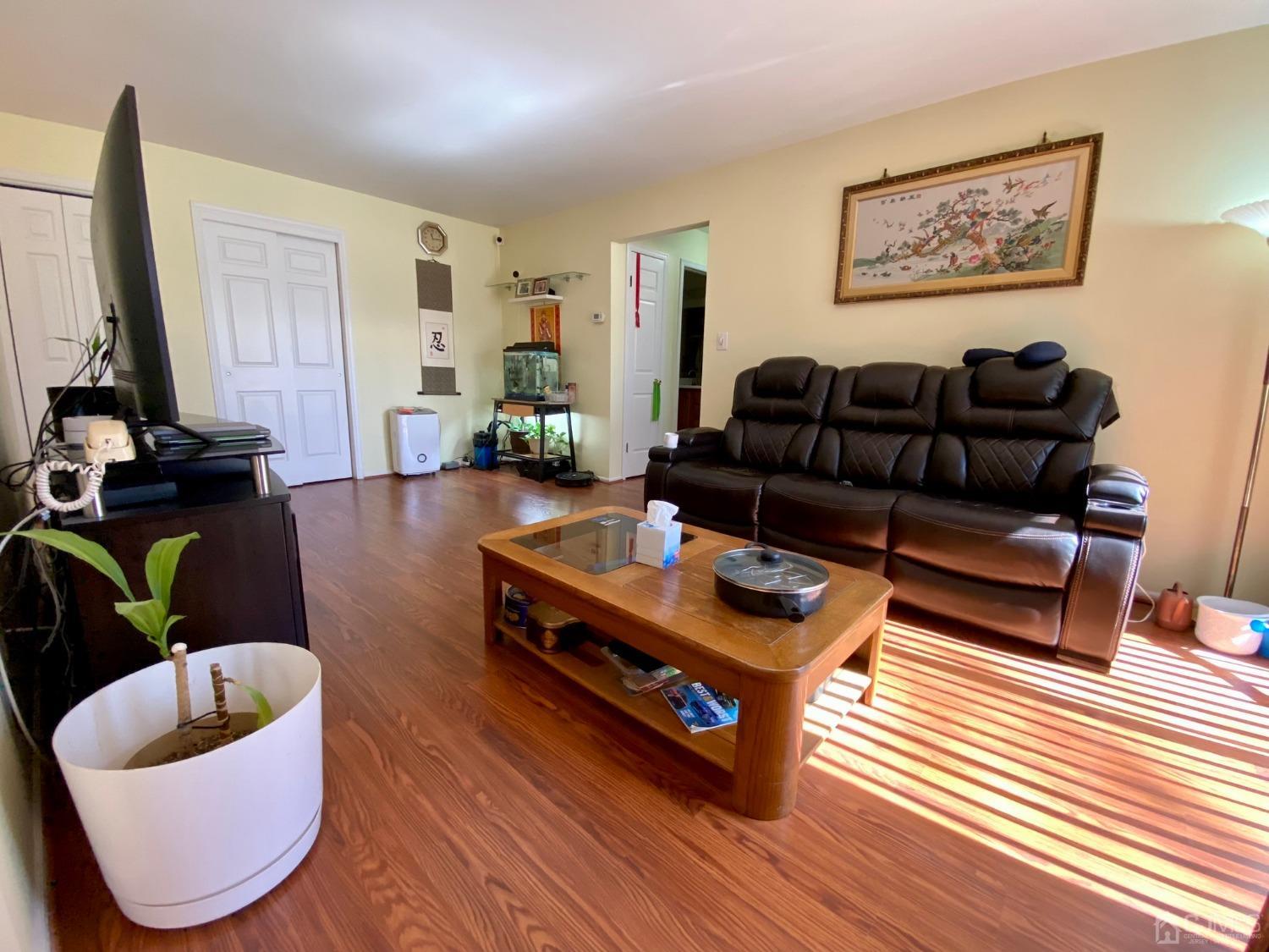51 Boulder Drive Edison, NJ 08817 - Photo 2 of 24 a living room with furniture a rug and a flat screen tv