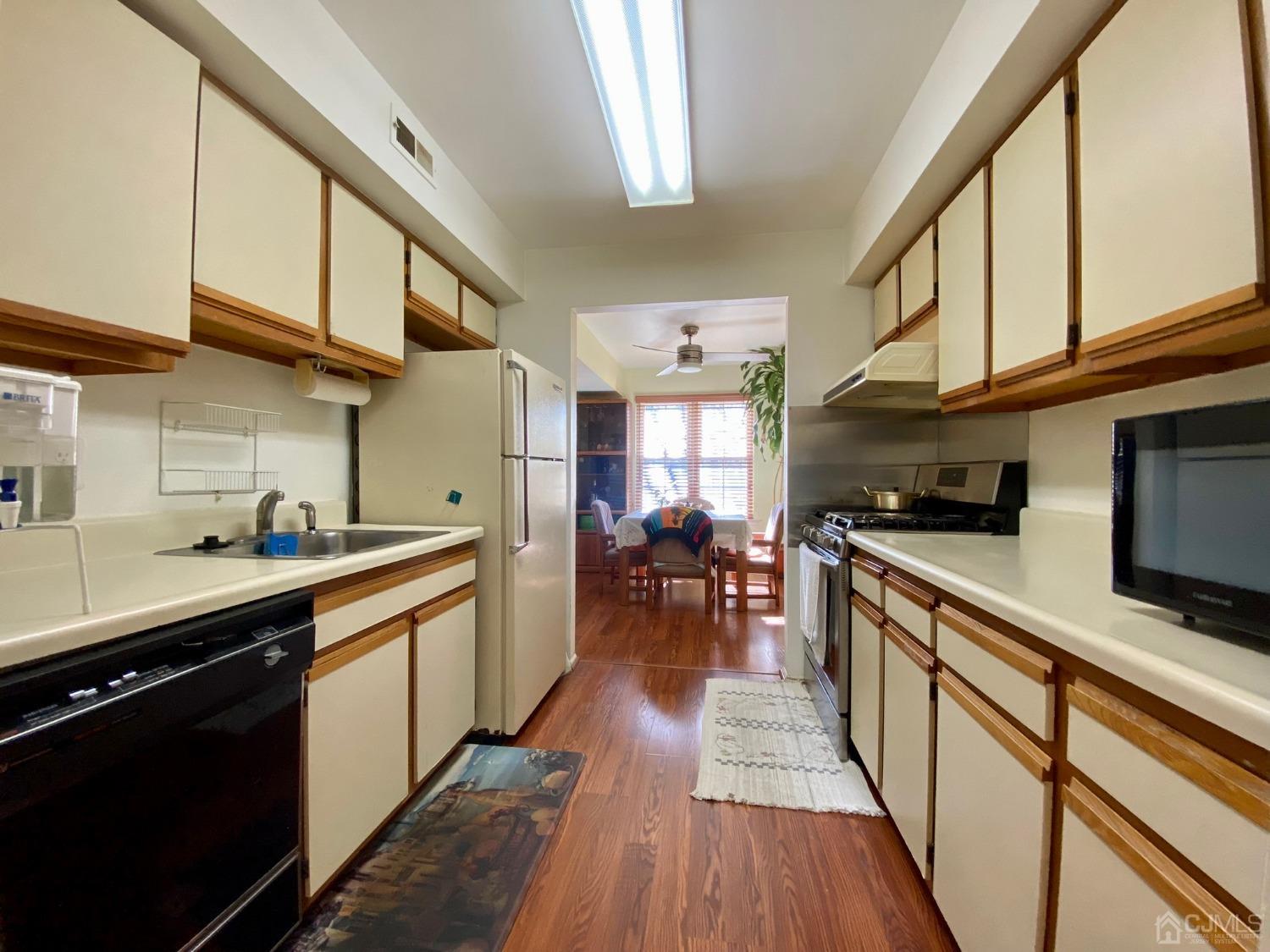 51 Boulder Drive Edison, NJ 08817 - Photo 7 of 24 a kitchen with lots of counter top space and wooden floor